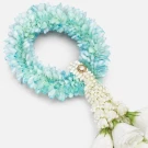 A light blue and white flower garland with white roses at the bottom.