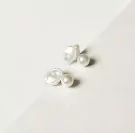 Pearl droplet earrings with luminous freshwater pearls and organic Keshi pearls on a white surface.