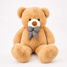 A giant, fluffy, light brown teddy bear wearing a black and white checkered bow.