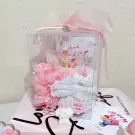 Candle gift box with tiny bear-shaped candles and pink tissue paper.