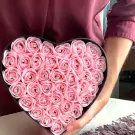 Heart-shaped box filled with pink roses, each with a small diamond accent.