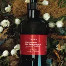 YA.H.N. nourishing body wash bottle with jasmine flowers and natural elements.