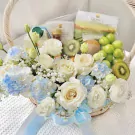 Get well soon basket with white roses, blue hydrangeas, kiwi, grapes, and Doikham products.