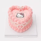 Heart-shaped pink cake with Hello Kitty decoration, piped frosting, and pearl accents.