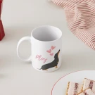 White mug with a dachshund illustration and pink hearts, reads "Ploy".