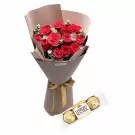 Bouquet of 12 red roses with eucalyptus, wrapped in brown paper with a gold ribbon, and two Ferrero Rocher chocolates.
