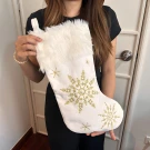 White Christmas stocking with gold snowflake embroidery and white faux fur trim.