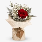 dried red rose bouquet with white baby's breath, wrapped in burlap.