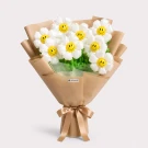 Bouquet of white daisy balloons with smiley faces, wrapped in brown paper and tied with a ribbon.