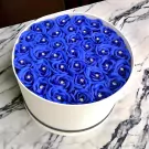 Round white box filled with 40 blue artificial roses, each with a diamond accent.