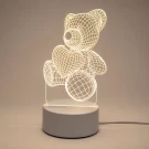 3D line art teddy bear lamp holding a heart and ball on a wooden surface.