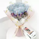 Money bouquet with pink and purple dried flowers and transparent money placeholders.