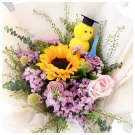 Graduation bouquet with yellow sunflower, pink roses, and a graduation-hat-wearing duck plushie.