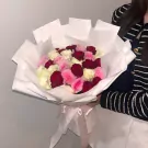 Bouquet of 30 white, pink, and red roses wrapped in white paper, tied with a light pink ribbon.