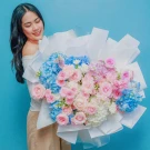 An grand fresh bouquet featuring a dreamy blend of serene blue hydrangeas and pastel pink roses.
