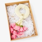 A white jasmine garland with pink roses in a gift box.