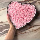 Pink heart-shaped box filled with 60 pink soy wax roses, each with a small diamond accent.