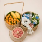 Bamboo basket with mangoes, plumies, and a flower garland, for Songkran.