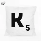 White pillow with black Scrabble letter K and number 5 tile design.