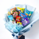 Snack bouquet with chips, Pocky, and Haribo candies in light blue paper.