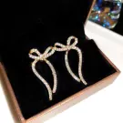 Sparkling silver ribbon earrings with cubic zirconia in a gift box.