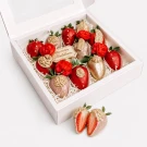 Chocolate-dipped strawberries and red roses in a white gift box, with a strawberry held above.