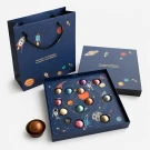Open Galaxy Chocolate Box with 12 planet-shaped chocolates and space-themed gift bag.