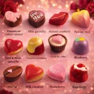 Assortment of 12 gourmet heart and uniquely shaped chocolates with flavor labels.