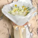 Creamy white roses, gerberas, and yellow craspedia bouquet with daisies, tied with a satin ribbon.