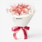 Money bouquet with 1000 Thai baht notes in white wrapping paper, tied with a pink ribbon.