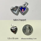 Heart-shaped locket necklace with photo and Thai coin for scale.