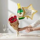 New Year's celebration bouquet with red roses, champagne bottle balloon, and star balloon.