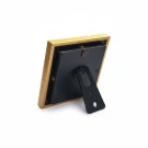 Back view of a gold picture frame with black backing and a black stand.