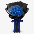 Bouquet of vibrant blue dried roses wrapped in black and white paper, tied with a blue ribbon.