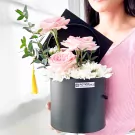 Black graduation box with pink roses, white mums, and yellow tassel.