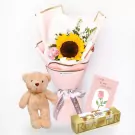 Sunflower bouquet, teddy bear, Ferrero Rocher chocolates, and a card with a rose.