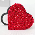 Heart-shaped box filled with red roses, each with a diamond center.