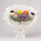 Bouquet of stuffed teddy bears in graduation caps with dried flowers, wrapped in white paper and tied with a white ribbon.
