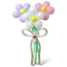 A balloon bouquet of three pastel daisies with yellow centers and green stems tied with a white balloon bow.