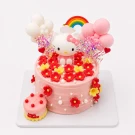 Pink Hello Kitty cake with flowers, balloons, and rainbow topper.