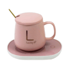 Pink ceramic mug with "L lucky" logo and lid on a pink heating pad saucer with a gold spoon.