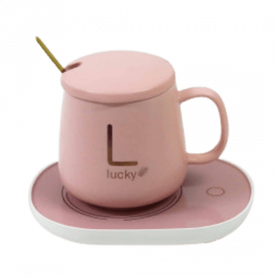 Pink ceramic mug with "L lucky" logo and lid on a pink heating pad saucer with a gold spoon.