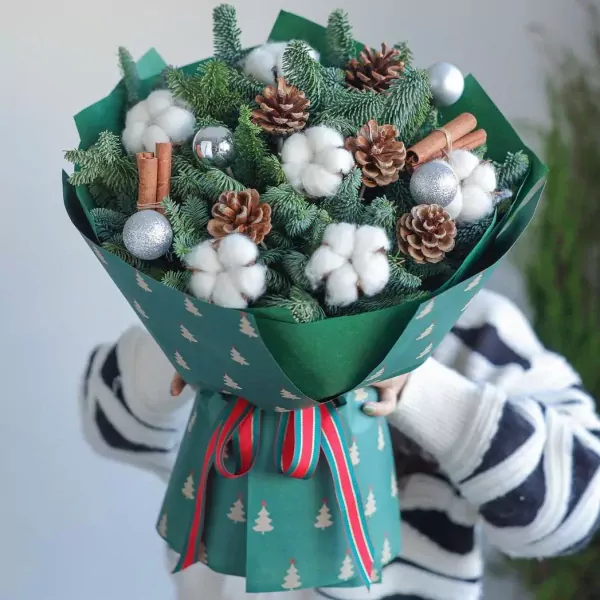 Christmas bouquet with pine, cotton, cinnamon, pine cones and silver ornaments.