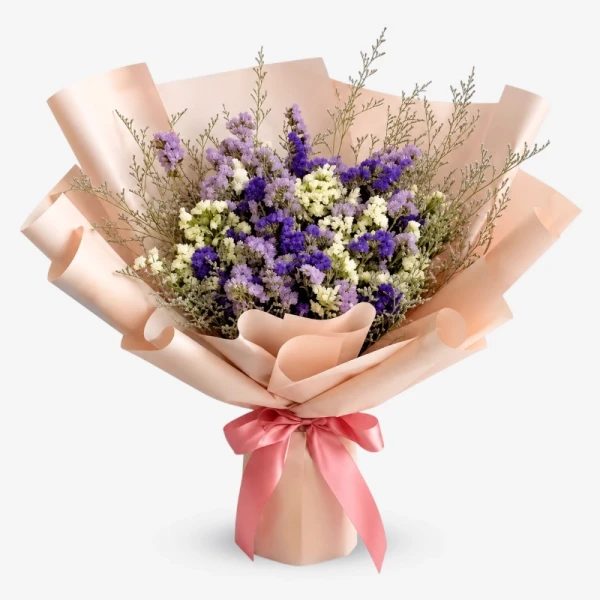 Bouquet of dried white, purple, and pink statice with violet caspia, wrapped in pink paper with a pink ribbon.