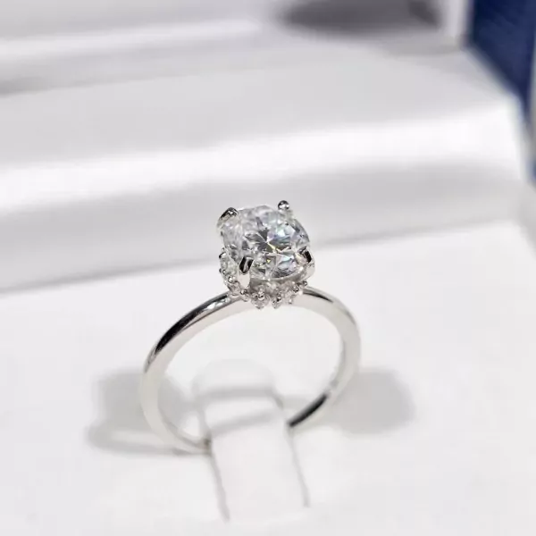 Oval-cut moissanite diamond ring with white gold plated band.