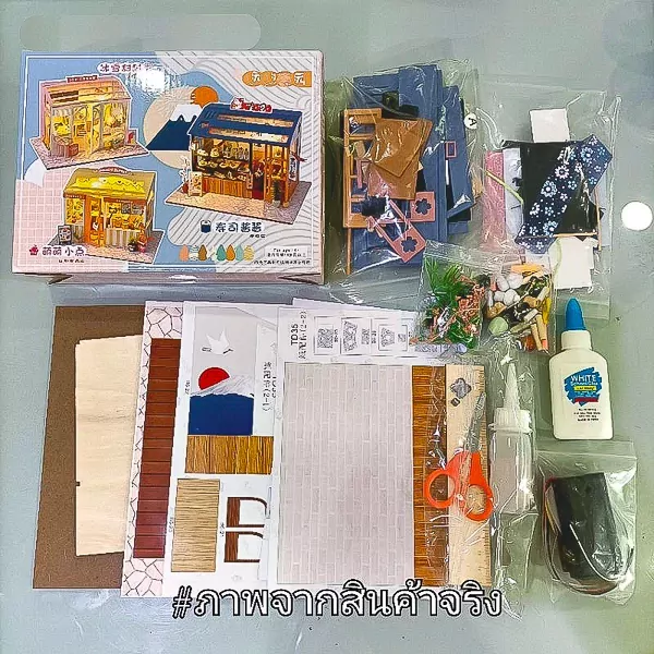 DIY Mini Sushi Restaurant kit with building parts, glue, scissors, and box.