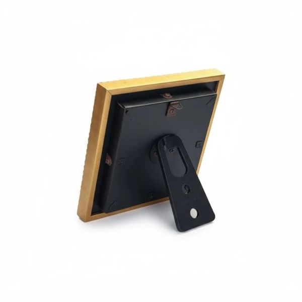 Back view of a gold picture frame with black backing and a black stand.
