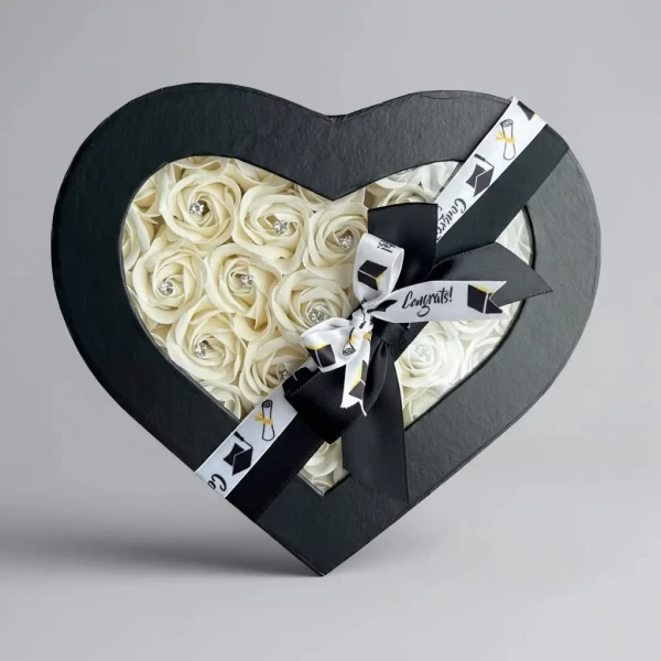 Heart-shaped black box with white roses and "Congrats!" ribbon, for graduation.
