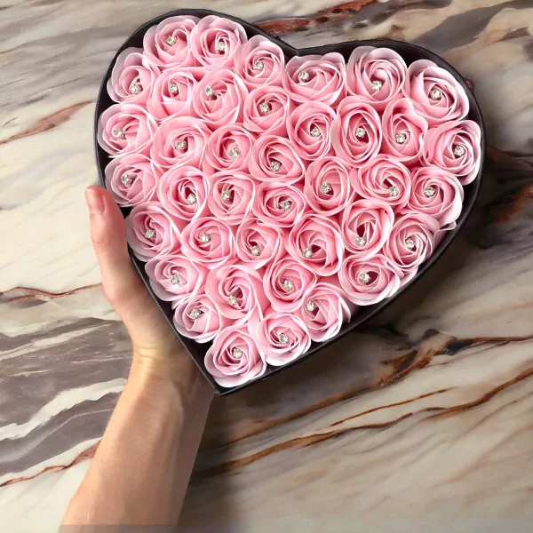 Pink heart-shaped box filled with 60 pink soy wax roses, each with a small diamond accent.