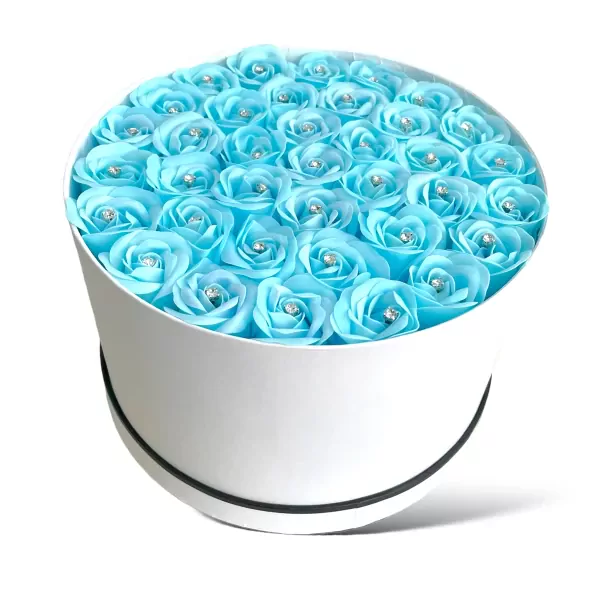 Round white box filled with 40 light blue artificial roses, each with a diamond center.